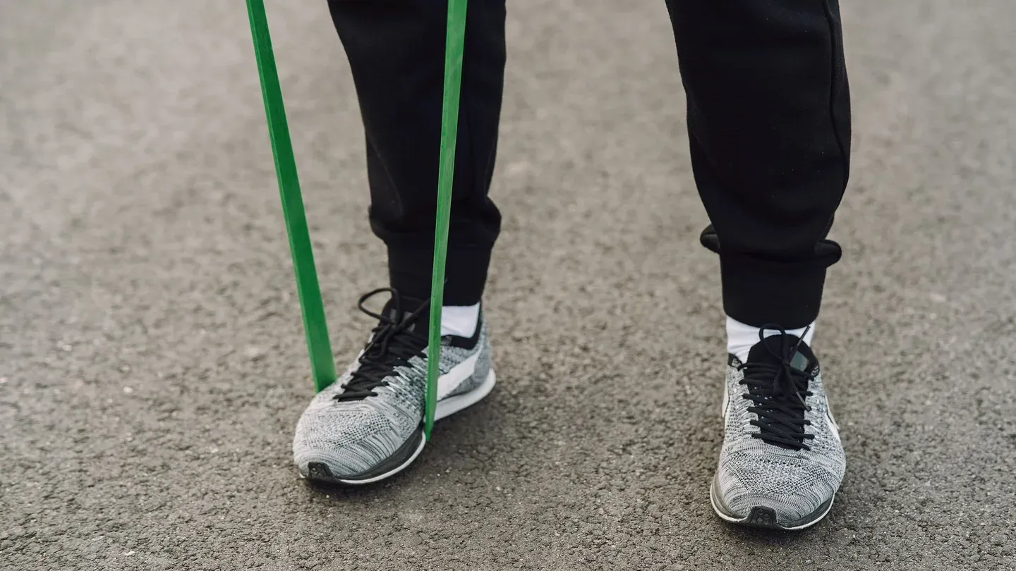 Pés presos com elástico de resistência para exercício de panturrilha Pés presos com elástico de resistência para exercício de panturrilha